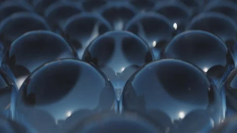 Array of many dark glass spheres. Transparent, reflective mirror material. Round Stock Footage 246056339