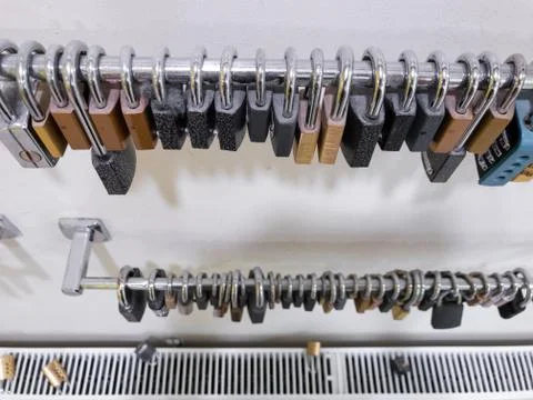 Array of pad locks hanging in a gym on the wall Stock-Fotos