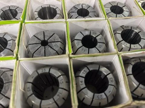 Array of precision metal collets neatly stored in individual compartments, .. Stock-Fotos