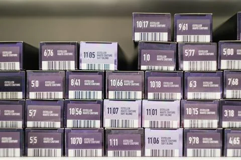 Array of purple boxes of hair dye with different shades and numbers on Stock Photos