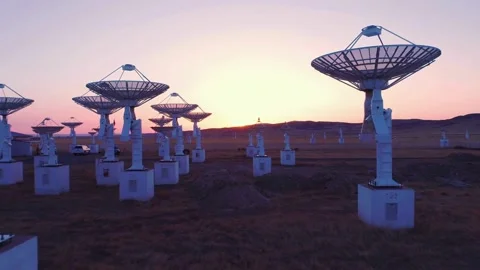 Array of radio telescopes at sunset in a field Stock Footage 333815181