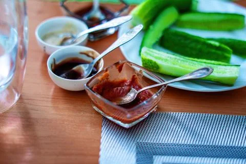 Array of sauces nestled in small bowls graces the dining table, inviting a bl Fotos de archivo