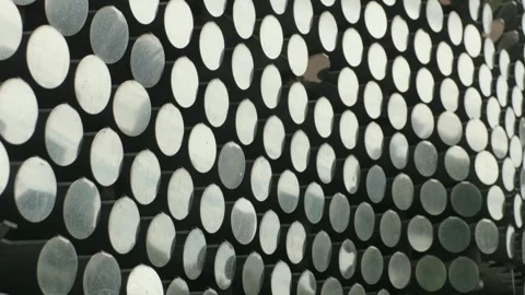 Array of shiny circular metal mirrors glimmers in daylight setting Vídeo Stock 344503409