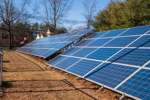 An array of solar panels in a field Stock Photos