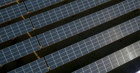An array of solar panels lying on a plot of land. Aerial drone shot. Vídeos de archivo 123642900