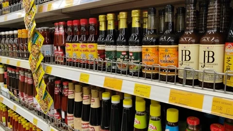 An array of soy sauce, chili, and tomato sauces bottle from diverse brands and Video stock 311555425