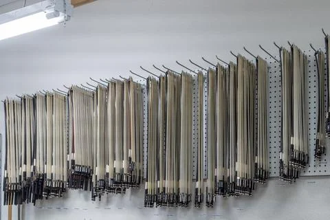 Array of strings for stringed musical instruments hanging on a wall 스톡 사진