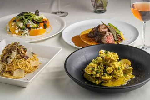Array of sumptuous gourmet dishes laid out on a restaurant table Stock Photos