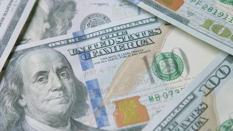 An Array of US Dollar Bills Displayed in CloseUp for Detailed Examination and An 스톡 사진