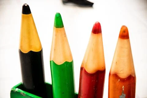 Array of vibrant colored pencils neatly arranged in a wooden holder placed on a Stock Photos