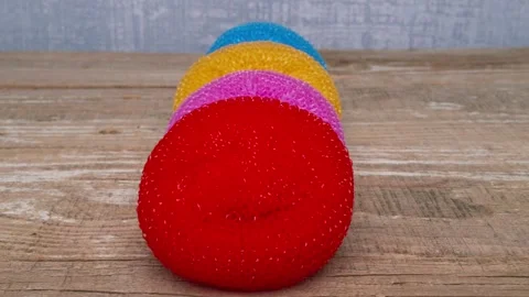 An array of vibrant, colorful soft foam balls are carefully stacked on a smooth Vidéo 290226925