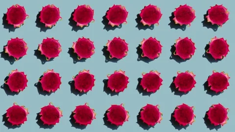 Array of vibrant dragon fruit halves rotating in symmetrical pattern Stock Footage 245249584