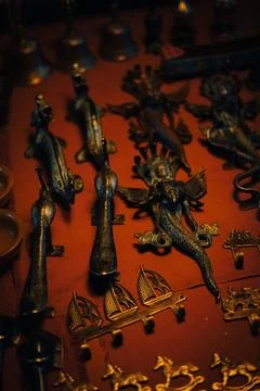 Array of vintage metal items are on sale, displayed against a vibrant red backgr Stock Photos