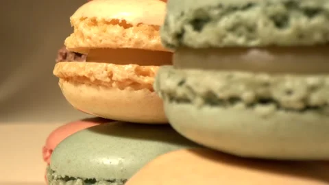 An array of vivid macarons draped together highlighting their smooth textures 库存影片 326276351