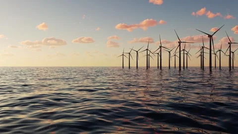 An array of wind turbines sits at sea generating electricity. Stock Footage 332571674