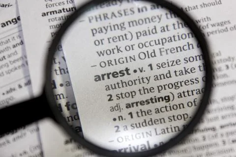 Arrest word or phrase in a dictionary. Stock Photos