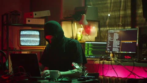 Arresting of hacker wearing balaclava, typing on keyboard, breaking password on Stock Footage 159417400