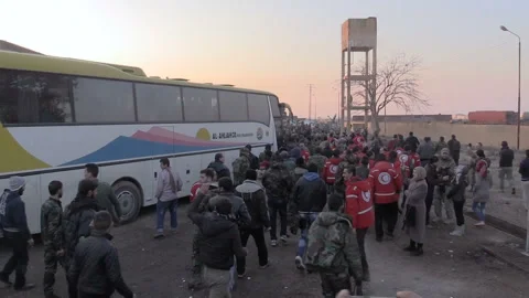 Arrival of a bus carrying evacuees from Foua and Kafriya to Jibrin near Aleppo Stock Footage
