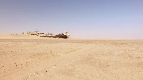 Arrival of a man in a jeep front of a wrecked boat, Namib Desert Stock Footage 103317451