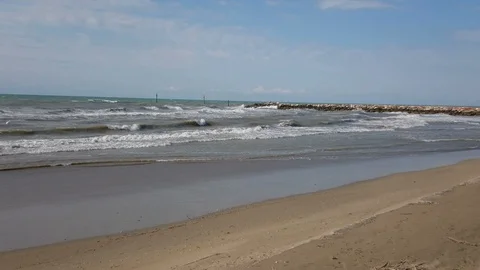 The arrival of a thunderstorm swells the waves of the sea and moves the sand Video stock 112579266