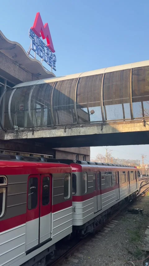 Arrival of train from Didube metro station with red letter M Stock Footage 303107034