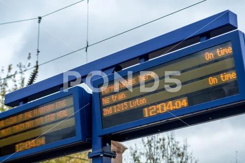 Arrivals and departures information sign at the train station Stock Photos