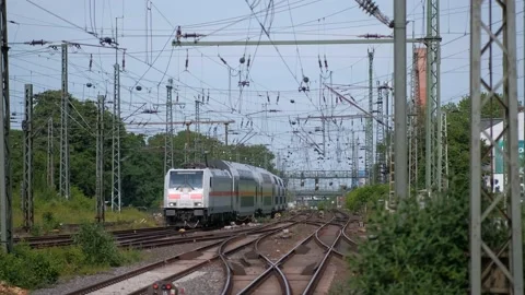 An arriving passenger train with double-decker cars to a station in Germany. Video stock 221553664