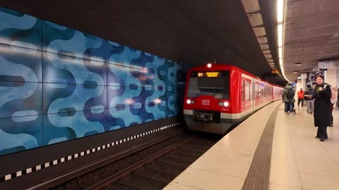 Arriving red train S-Bahn and platform with passengers in Hamburg Stock Footage 343254280