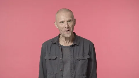 Arrogant and annoyed, grumpy middle-aged man grimacing, chuckle and move jaw Video stock 128650036