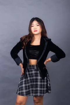 Arrogant girl posing formally while holding hands casually now Stock Photos