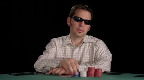 Arrogant poker player plays with chips as he awaits his turn Stock Footage 53238172