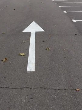 Arrow on asphalt Stock Photos