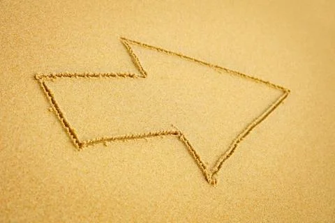Arrow on beach sand Stock Photos