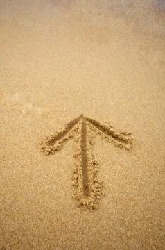 Arrow in beach sand Stock Photos