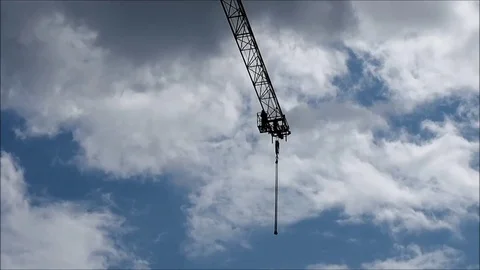 Arrow of a crane and the man against the sky, different clouds Stock Footage 82272960