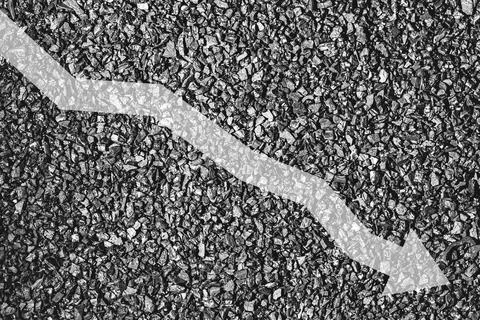 Arrow down on coal background. The concept of falling prices, mining, impor.. Stock Photos