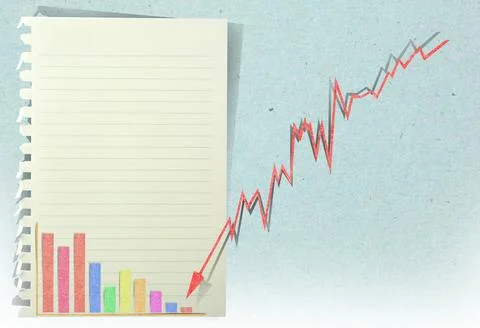 Arrow graph going down with staple recycled paper craft stick . Stock Photos