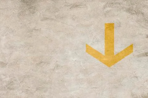 Arrow on grungy wall pointing down Stock Photos