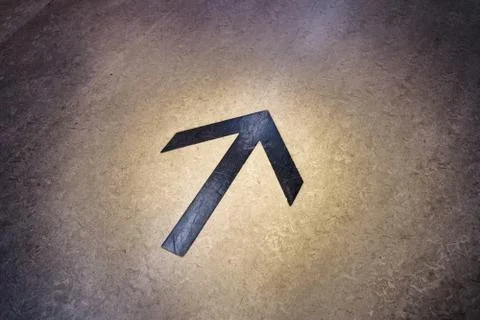 Arrow mark on floor of a large facility helps shopping customers navigate qui Stock Photos