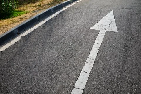 Arrow painted on the road that indicates the mandatory direction that vehic.. Stock Photos