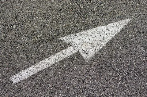 Arrow on pavement Stock Photos
