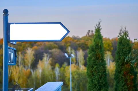 Arrow pointer with place for text on the background of trees and sky Stock Photos