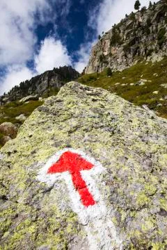 An arrow pointer on the rock in Val D' Arpette in the Swiss alps on the Tour du Stock Photos