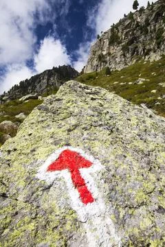 An arrow pointer on the rock in Val D' Arpette in the Swiss alps on the Tour  Stock Photos