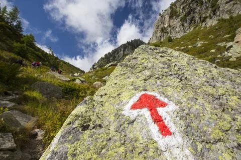 An arrow pointer on the rock in Val D' Arpette in the Swiss alps on the Tour  Stock Photos