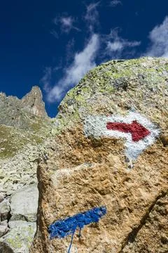 An arrow pointer on the rock in Val D' Arpette in the Swiss alps on the Tour  Stock Photos