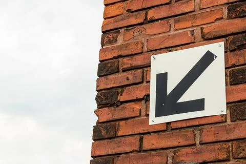 Arrow pointing down and to left Stock Photos