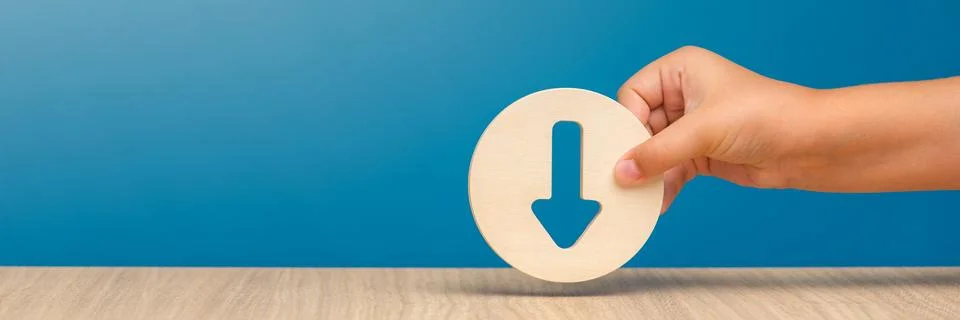Arrow pointing down on a blue background. Banner with an arrow in a wooden Stock Photos