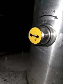 Arrow Points to Open Setting on a Valve in a Facility Stock Photos