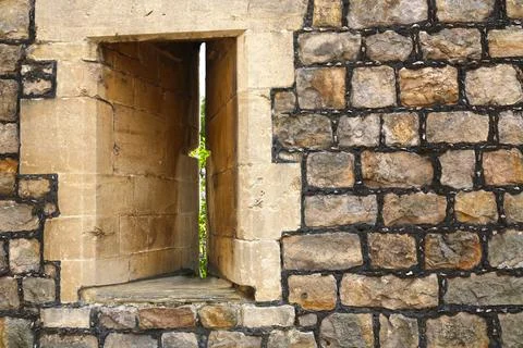 Arrow slit window vertical aperture at Windsor Castle. Stock Photos